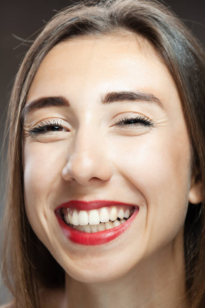 Beautiful brunette girl studio portrait. Smiling face expression. - Fotografie, Obrázek