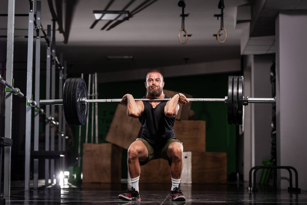 Muscular athlete lifting very heavy barbell.  - Fotografie, Obrázek