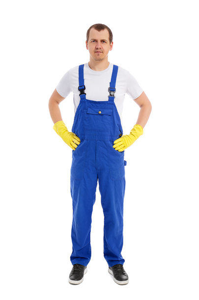 full length portrait of male cleaner in blue uniform and yellow gloves posing isolated on white background - Foto, Bild