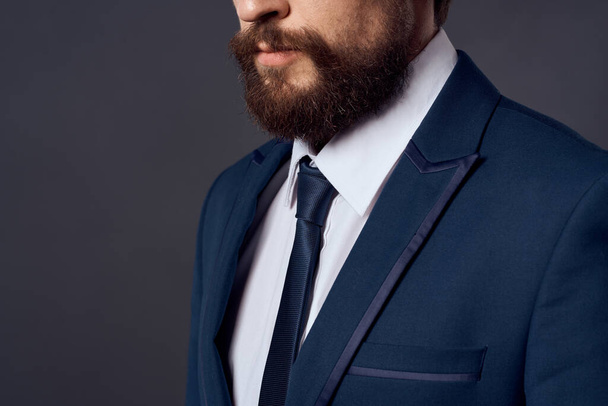 man in suit tying tie elegant style dark background - Foto, Bild