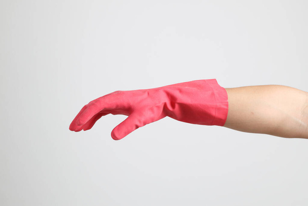 The pink gloves on the white background. - Foto, imagen