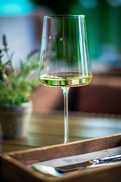 white wine on the wooden table - 写真・画像