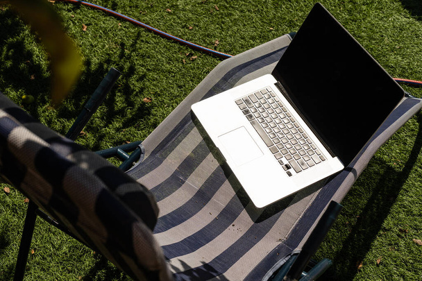 laptop on a sun lounger side view - 写真・画像