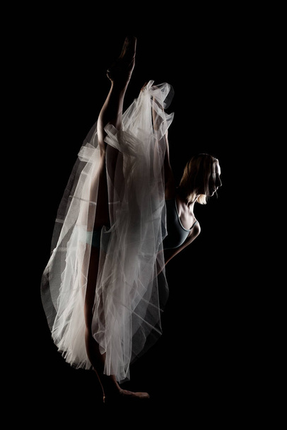 ballerina with a white dress and black top posing on black background - Photo, image