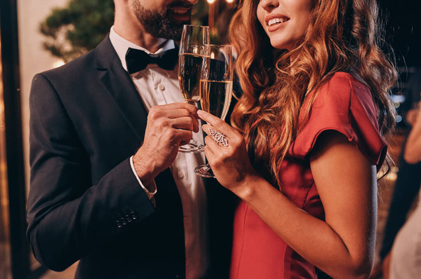 Close up of beautiful young couple in formalwear toasting with champagne while spending time on luxury party - Fotografie, Obrázek
