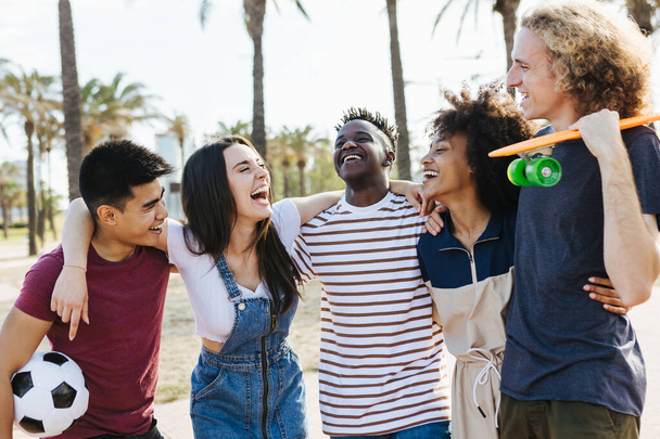 Fröhliche multirassische Freunde lachen und haben Spaß im öffentlichen Park - Foto, Bild