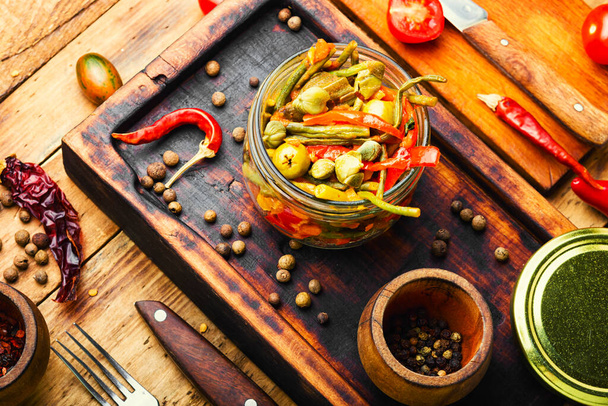 Spicy salad of stewed vegetablesSpicy appetizer of peppers,asparagus beans,olives and tomato - Fotoğraf, Görsel