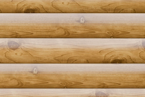 A superfície texturizada da parede de uma casa feita de troncos de madeira arredondados. - Foto, Imagem