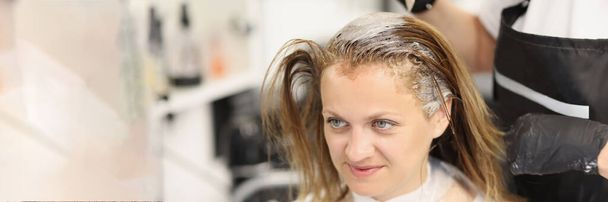 Hairdresser dying hair of client woman in barbershop - Photo, Image