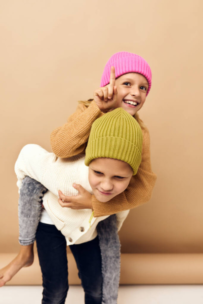 маленькая девочка и мальчик вместе в разноцветных шляпах весело повседневной одежды Студия стиль жизни - Фото, изображение