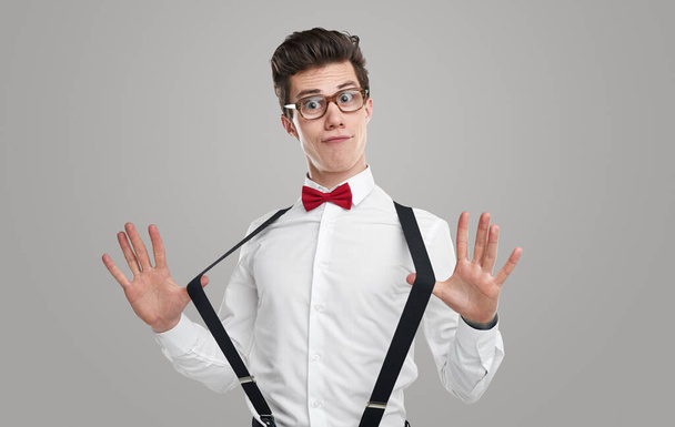 Confident young student stretching suspenders - Photo, image