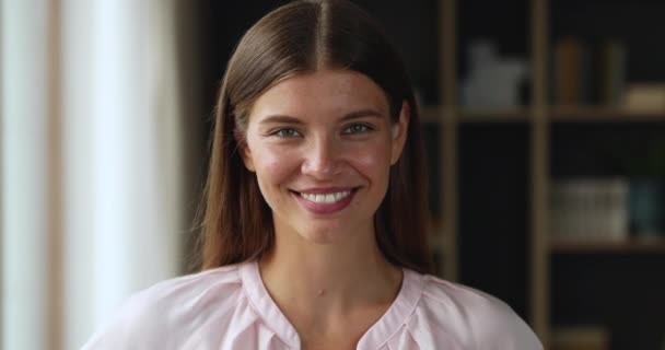 Beautiful laughing female teenager looking at camera in joyful mood - Felvétel, videó