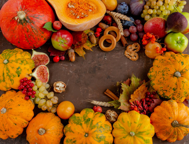 Autumn composition, Thanksgiving or Halloween concept, fruits, pumpkin on a brown background. Flat lay, copy space - Fotoğraf, Görsel