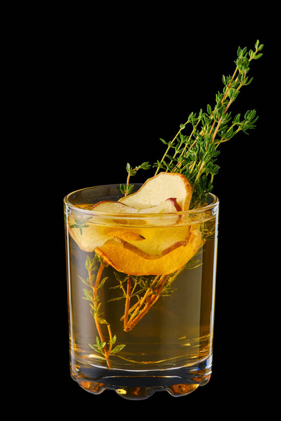 Hot apple winter drink with thyme and ginger isolated on black - 写真・画像