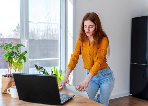 Young woman is education online by using computer. Female freelancer browsing in laptop. Concept of information overload. Technology and people. Comfort Zone at home. Networking business. - Φωτογραφία, εικόνα