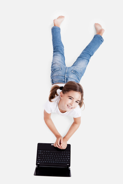 Little student girl with a laptop - Foto, imagen