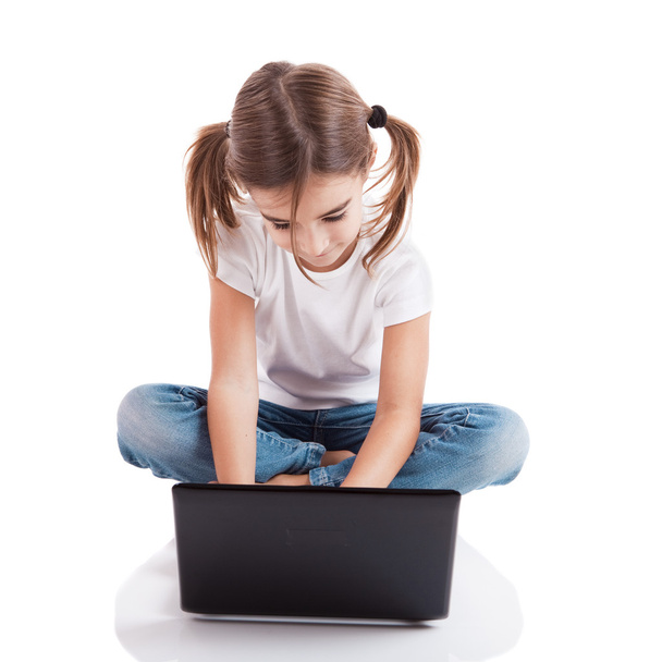 Little student girl with a laptop - Фото, изображение