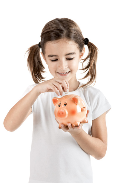 Little girl with a piggy-bank - Фото, изображение