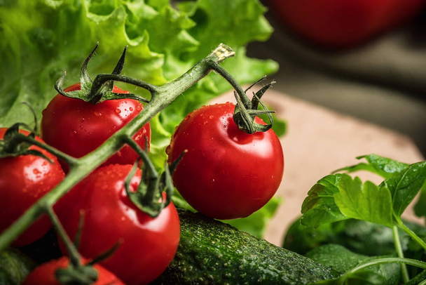 Vegetarian still life. Raw vegetables. Red tomatoes on a green background. - Fotografie, Obrázek