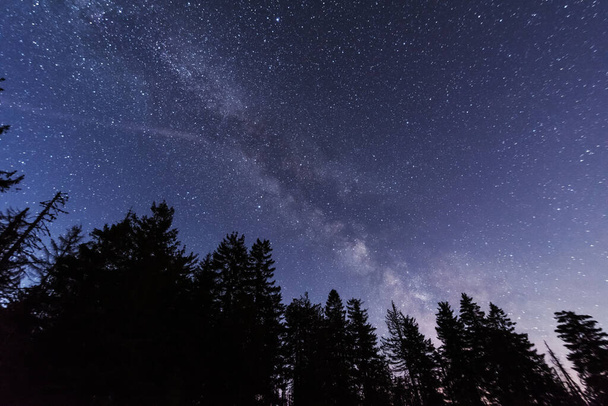 Bright starry sky with the milky way on the background of High Tatras mountains - Foto, Imagen