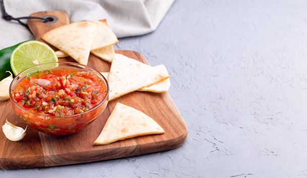 Salsa Asada sauce with tortilla chips and lime, Tex-Mex cuisine, horizontal, copy space - Zdjęcie, obraz