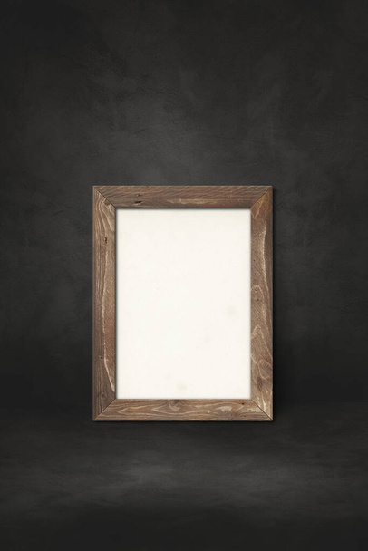 Wooden picture frame leaning on a black wall. Presentation mockup template - Foto, Imagen