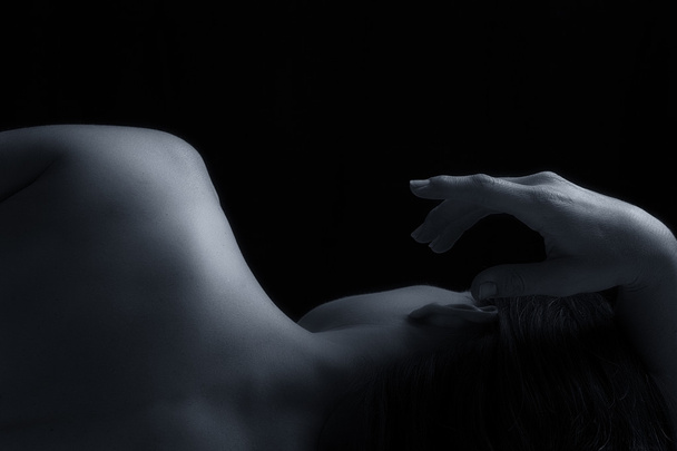 Body scape of woman back in low light emotion artistic conversio - 写真・画像