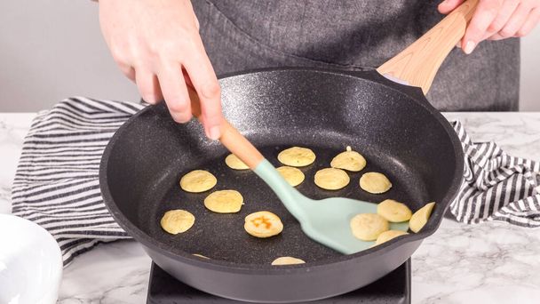 Step by step. Frying mini pancake cereal in a nonstick frying pan. - Valokuva, kuva
