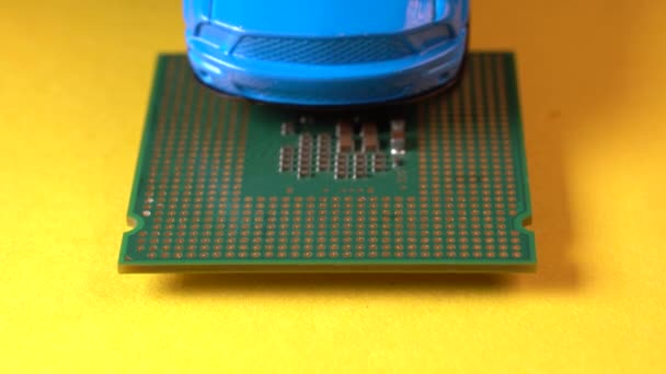 Close up view of a blue toy car on top of a microprocessor. - Footage, Video