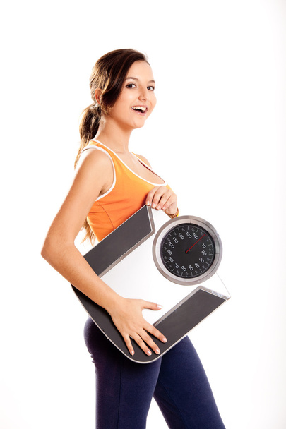 Athletic girl with a scale - Photo, image