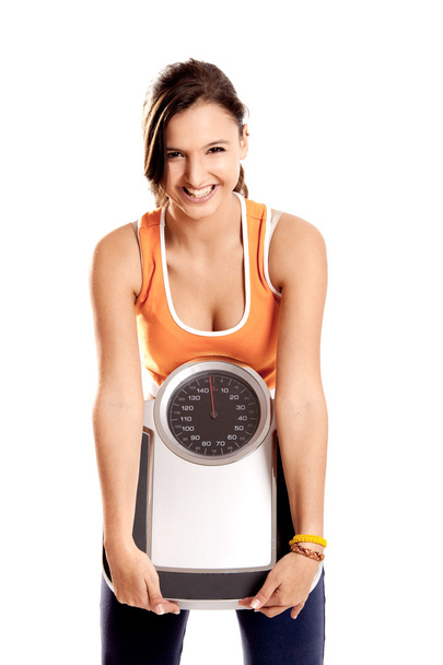 Athletic girl with a scale - Фото, изображение