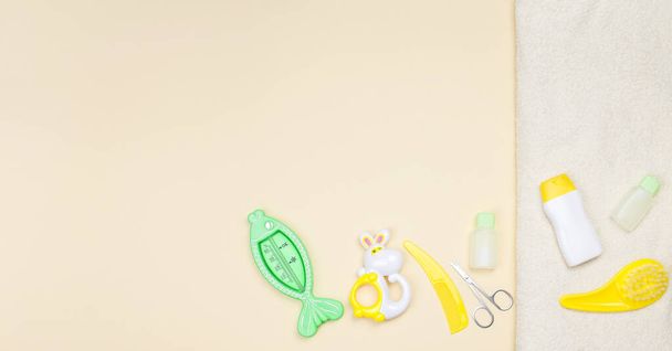 Baby shower accessories, towel and toy on light background with copy space - Zdjęcie, obraz