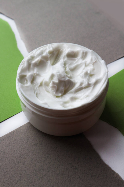Close-up of open jars of face creams on a gray background - Photo, Image