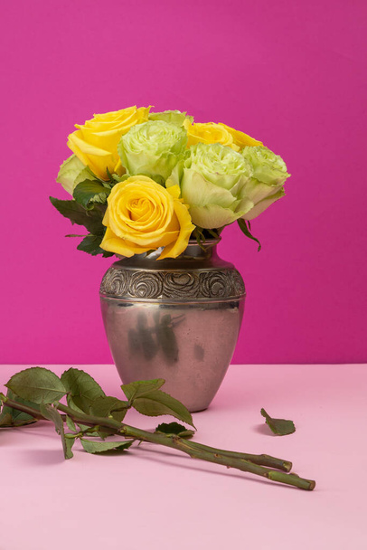 flower arrangement with yellow and white roses inside a metal vase, decoration with beauty of natural flowers in a studio, detail of nature and objects - Photo, Image