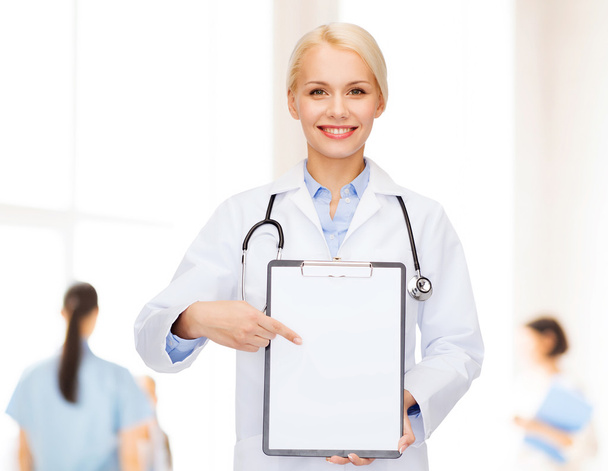 smiling female doctor with clipboard - Zdjęcie, obraz