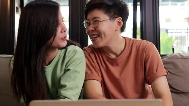 Azjatyckie lesbijskie pary mieszkające razem w domu czatować z przyjaciółmi poprzez rozmowy wideo online na laptopie. Oddalenie społeczne w celu zapobieżenia infekcji koronawirusem. Koncepcja LGBT - Materiał filmowy, wideo