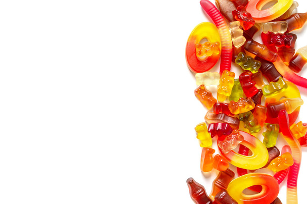 A pile of assorted of chewy jelly fruit candies on a white background. Copy space. Holiday concept, children delighted, unhealthy nutrition. - Foto, Imagem