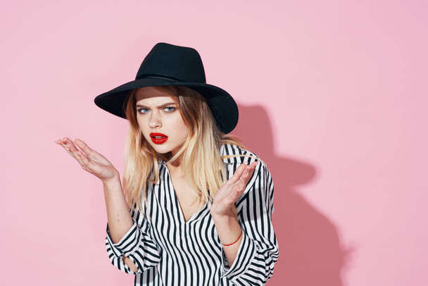 glamorous woman in black hat and striped shirt bright makeup pink background - Zdjęcie, obraz