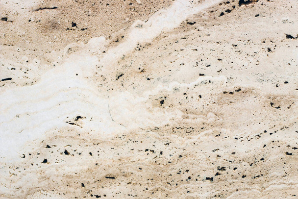 the texture of natural stone in a beige shade is similar to marble. - Foto, immagini