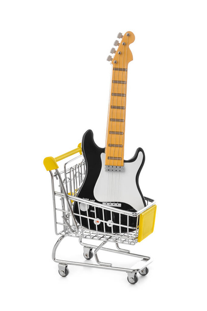 Toy electric guitar in shopping cart isolated on white background - Foto, Imagen