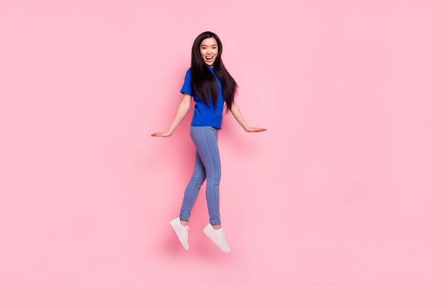 Full size photo of happy cheerful nice woman jump up walk good mood isolated on pastel pink color background - Φωτογραφία, εικόνα