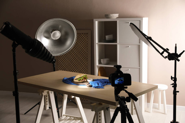Professional camera on tripod and composition with tasty sandwich in photo studio. Food photography - Φωτογραφία, εικόνα