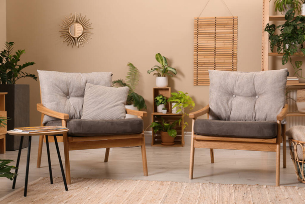 Lounge area interior with comfortable armchairs and beautiful houseplants - Φωτογραφία, εικόνα