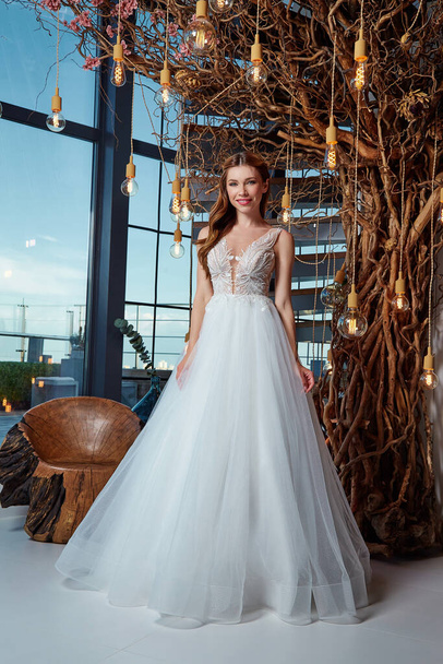 Beautiful woman bride fashion model brunette hair bright makeup pretty wear long silk white dress with lace bridal ceremony wedding espousal in blooming romance garden party marriage happy big day. - Foto, Bild