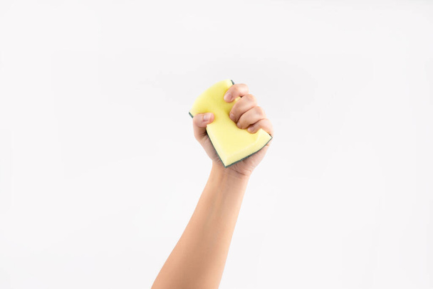 Hand holding a cleaning sponge on a white background. - Foto, immagini