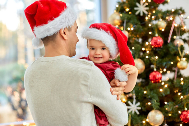 happy father and baby girl over christmas tree - Zdjęcie, obraz