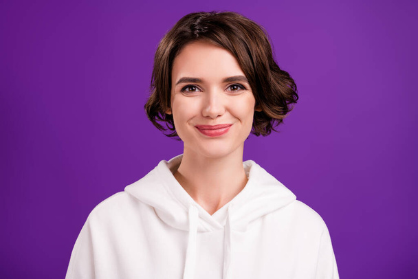 Portrait of young pretty smiling positive gorgeous female wear white hoodie sweater isolated on violet color background - Фото, зображення