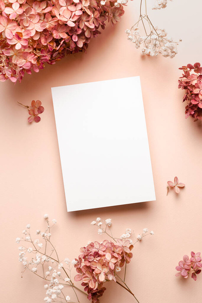 Invitation or greeting card mockup with trendy hydrangea and gypsophila flowers decorations. - 写真・画像