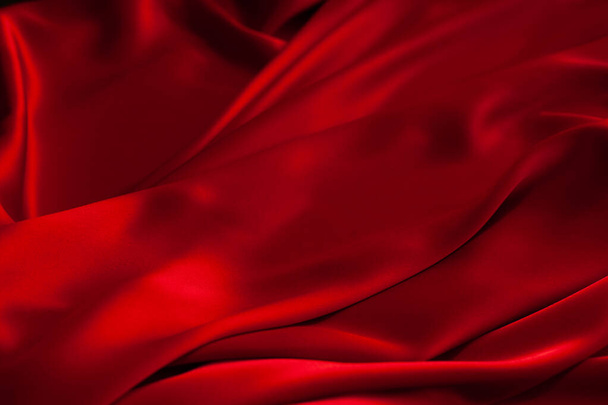 Red fabric texture background. Silk satin folds. Smooth elegant wallpaper - Photo, image