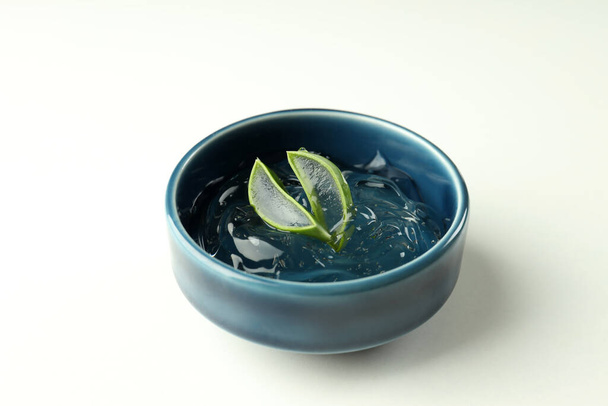 Bowl with aloe gel and slices on white background - Photo, Image